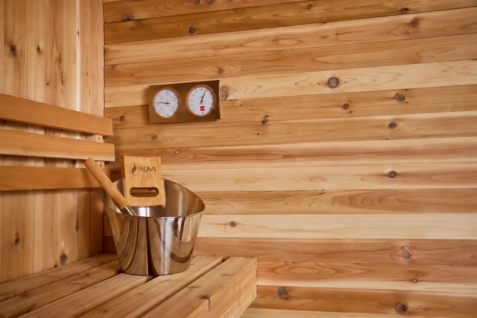 Timber sauna benches and wall lining with gauges and bathing accessories
